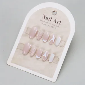 Short oval nude pink and white French press-on nails with spiral shell texture and wave patterns