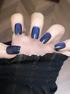 Detailed view of navy blue cat-eye square press-on nails with metallic shimmer effect