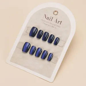 Midnight blue cat eye press-on nails in short square shape on display card