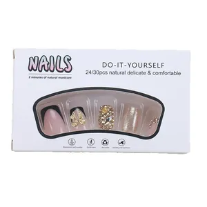 Pink French press-on nails with black tips, glitter, and rhinestone bow decoration