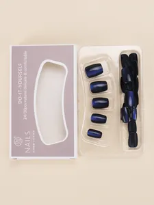 Detail of blue cat-eye and matte black press-on nail kit in windowed paper packaging