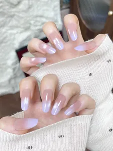 Detail of almond-shaped press-on nails with purple gradient and aurora pearl finish