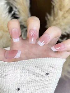 Detail of short square press-on nails with nude gradient and white French tips