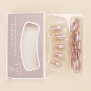 Close-up of cat-eye gradient pink nails with minimalist DIY packaging and tools