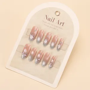 Handmade leopard print press-on nails with cat-eye gradient and rhinestones in long coffin shape
