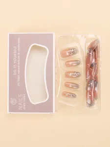 Detail of pink gradient cat-eye press-on nails with leopard print and rhinestones in box