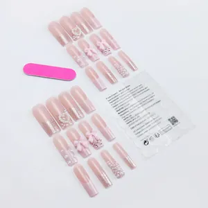 French press-on nails with pink 3D bows, pearls, and glitter gradient on a white background