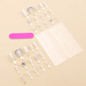 Pearly white toe nail kit with silver glitter and rhinestones on soft pink background