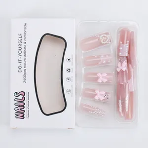 Pink press-on nail kit with pearl bows and rhinestone accents in a white display box