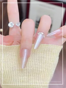 Detailed view of long coffin cat-eye press-on nails with glitter and rhinestones