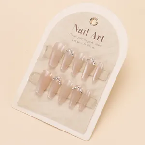 Pink press-on nails with silver rhinestones and glossy finish in long coffin shape