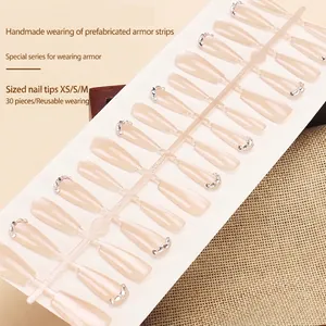 Press-on nail set with 30 nude cat-eye pieces featuring rhinestones and handmade finish