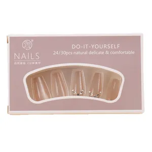 Long ballet cat eye press-on nails in nude pink with silver rhinestone accents