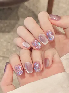Macro detail of lavender cat-eye press-on nails with sparkling glitter and rhinestones