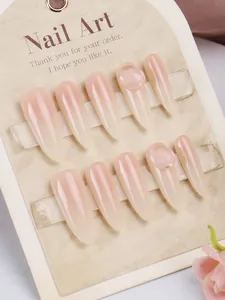 Detail of 10pcs almond-shaped press-on nails with nude pink gradient and 3D accents