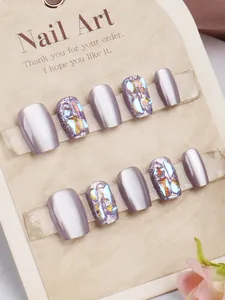 Detail of handmade purple aurora nails with metallic finish and glitter rhinestones
