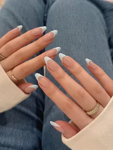 Detail of almond nails with 3D white wavy French tips and natural pink base