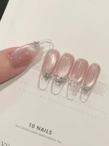 Detailed view of nude gradient press-on nails with silver star and petal diamond accents