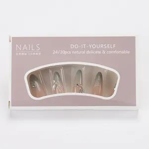 Detail of blue-grey gradient press-on nails with rhinestones and 3D butterfly charms
