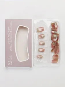 Detail of DIY cat eye press-on nails set with pink gradient and small rhinestones
