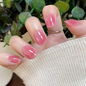 Short square round press-on nails in translucent jelly pink with a glossy cat eye finish