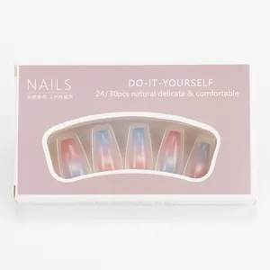 Detail of pink and blue ombre press-on nails with glitter in windowed box packaging
