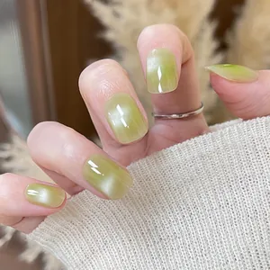 Handmade light green cat eye press-on nails with shimmery finish and square round shape