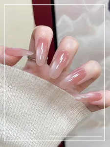 Detailed view of long almond-shaped pink gradient cat-eye press-on nails with glitter