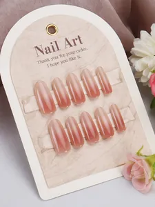 Detail of pink gradient cat-eye press-on nails in long almond shape on floral satin background