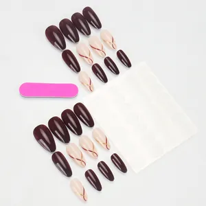 Deep wine red and cream almond press-on nails with minimalist gold and red stripes