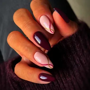 Glossy almond press-on nails with minimalist gold stripes and deep purple solid finish