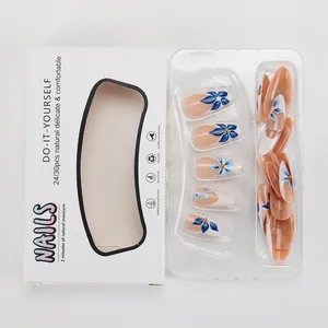Blue floral press-on nails with French white tips and 3D gold details in packaging