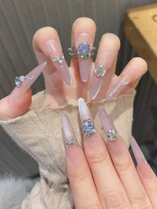 Detail of lavender cat-eye press-on nails with purple heart crystal and silver accents