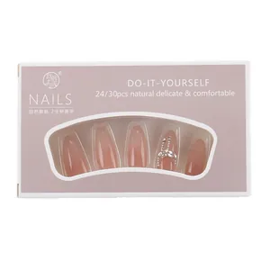 Handmade cat eye press-on nails in nude pink with rhinestones and pearl accents