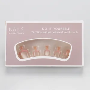 Macro shot of 24pcs nude pink French toe press-on nails in branded retail packaging