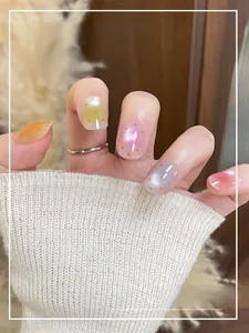 Detail showing colorful square round press-on nails with cute orange polka dots
