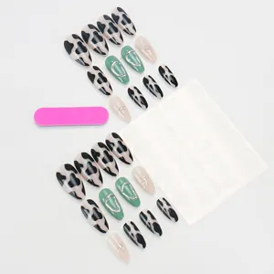 Press-on nail set featuring cow print and metallic star designs on 24 long oval tips