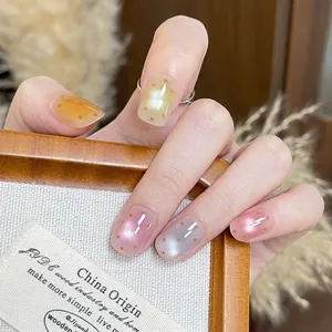 Short square press-on nails with macaron colors, orange dots, and aurora cat-eye effect