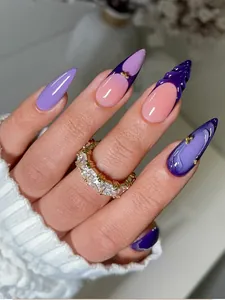 Detail of purple and pink gradient press-on nails with 3D spiral texture and gold beads