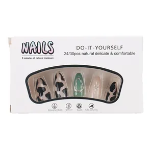 Coffin press-on nails featuring 3D star patterns, cow prints, and metallic ring accents
