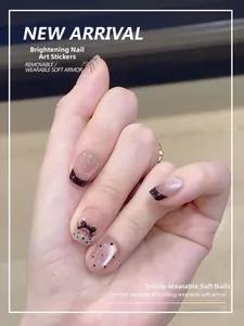 Detailed view of dark gothic press-on nails with black dots and 3D bowknot accents
