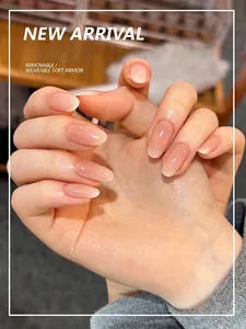 Detailed view of nude pink gradient press-on nails in oval shape with glossy finish