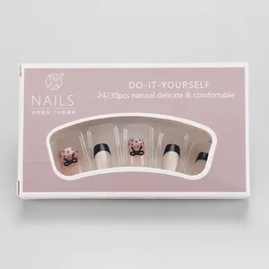 Detail of gothic press-on nails with black bow, dots and 24/30 pieces packaging