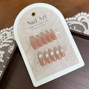 Pink gradient cat-eye oval press-on nails set displayed on a wooden tray with lace deco