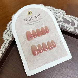 Short oval gradient pink press-on nails with a glossy finish on a display card