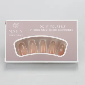 Detail view of pink gradient press-on nails in branded window packaging box