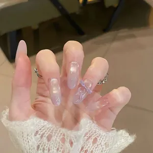 Macro detail of long almond press-on nails with lilac gradient and 3D bow accent