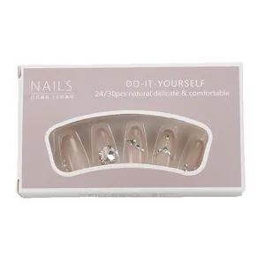 Press-on nail set in nude pink with large rhinestones and silver chain accents