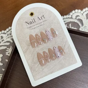 Handmade almond press-on nails with pink plaid pattern, pearls and rhinestone accents