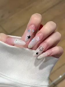 Macro detail of almond press-on nails with cat motifs and white 3D bows